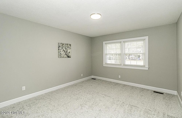 unfurnished room with light colored carpet