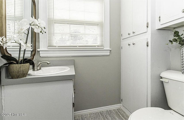 bathroom with vanity, plenty of natural light, and toilet