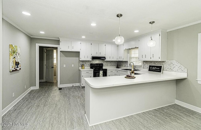 kitchen with black range with electric stovetop, sink, hanging light fixtures, and kitchen peninsula