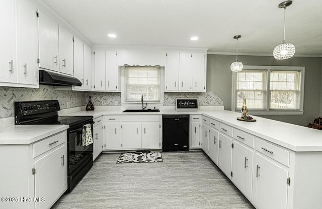 kitchen featuring hanging light fixtures, white cabinetry, sink, and black appliances