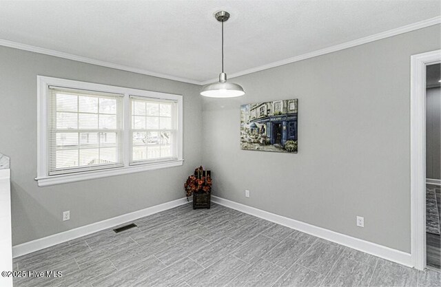 empty room featuring ornamental molding