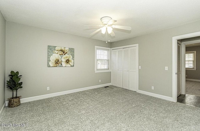 unfurnished bedroom featuring carpet floors, a closet, and ceiling fan