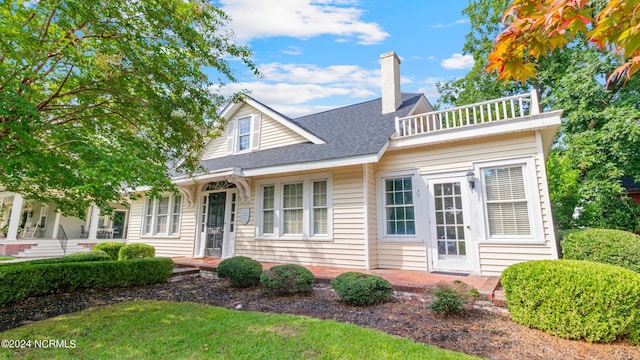103 NW Fourth St, Snow Hill, NC 28580 - view of front facade featuring roof with shingles, a balcony, and a chimney
