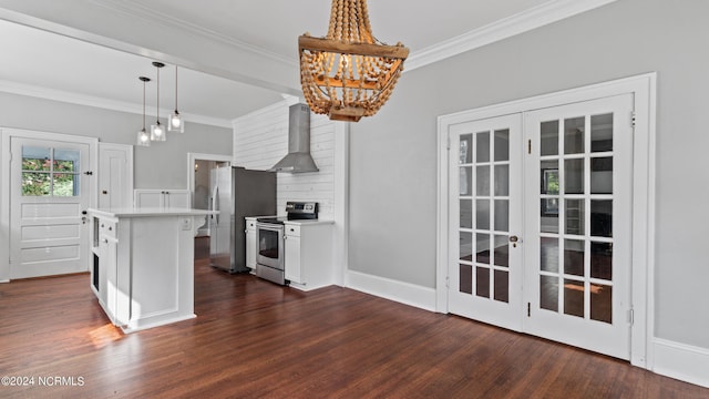 kitchen with light countertops, appliances with stainless steel finishes, wall chimney exhaust hood, dark wood finished floors, and crown molding