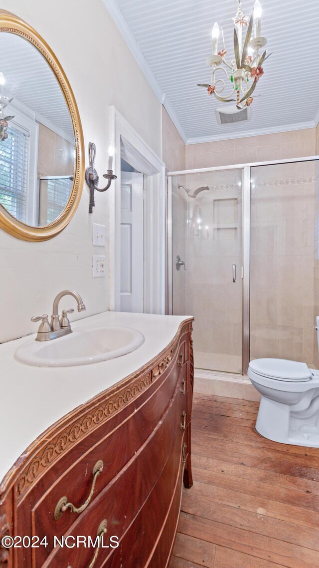 bathroom with vanity, wood-type flooring, a notable chandelier, and crown molding