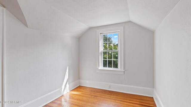 bonus room featuring light hardwood / wood-style flooring and lofted ceiling