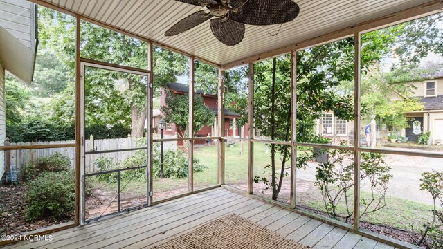 unfurnished sunroom with wooden ceiling, ceiling fan, and plenty of natural light