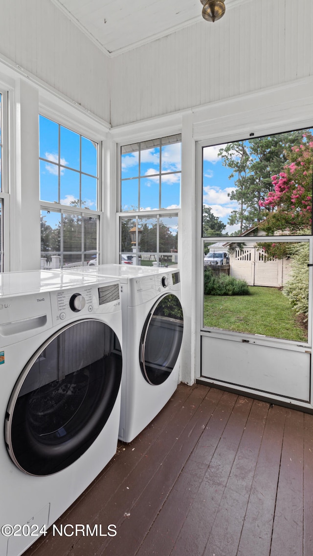 laundry room featuring independent washer and dryer, dark hardwood / wood-style floors, and plenty of natural light