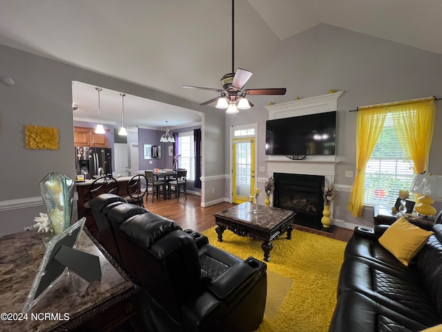 living room with ceiling fan, lofted ceiling, and hardwood / wood-style flooring