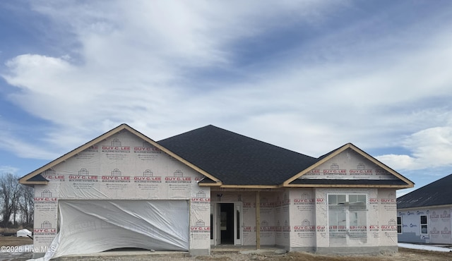 property in mid-construction featuring brick siding, roof with shingles, and an attached garage