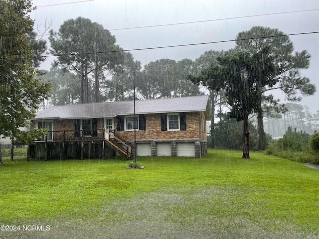 view of front of house with a wooden deck and a front yard