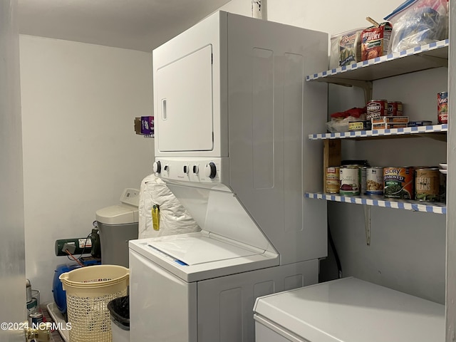 laundry room with laundry area and stacked washer / dryer