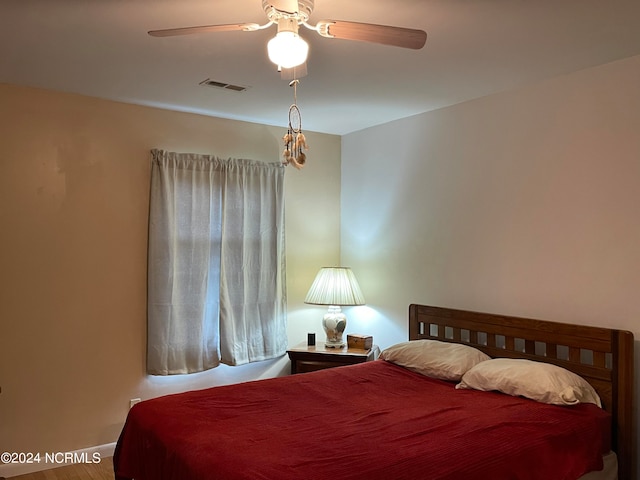 bedroom with ceiling fan and wood-type flooring