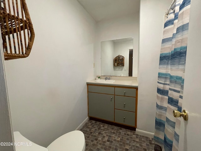 bathroom with vanity, toilet, and tile patterned flooring