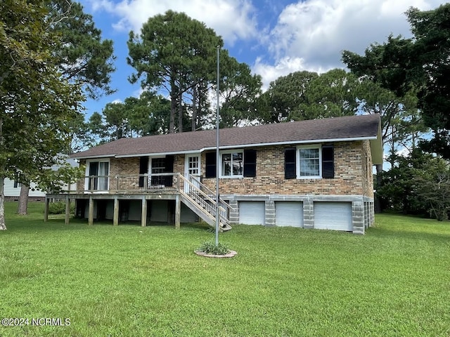 view of front of home with a front lawn, brick siding, an attached garage, and stairs