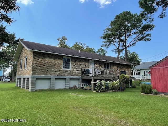 back of property featuring brick siding, a yard, and an attached garage