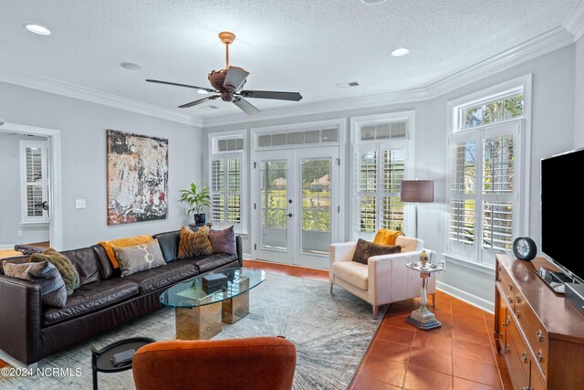 living room with a textured ceiling, a healthy amount of sunlight, ceiling fan, and ornamental molding