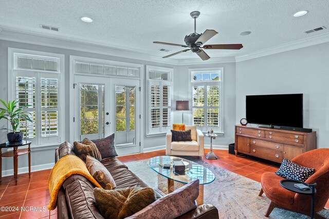 tiled living room with ceiling fan, crown molding, and a textured ceiling