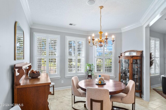 tiled dining area featuring ornamental molding, a textured ceiling, a healthy amount of sunlight, and a chandelier