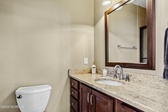 bathroom featuring toilet and vanity