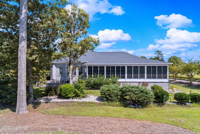 view of front of house with a sunroom