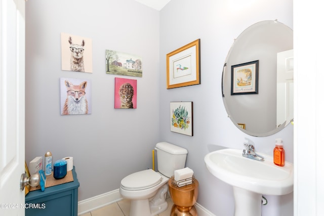 bathroom featuring sink, tile patterned floors, and toilet