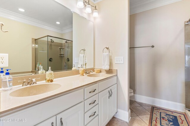 bathroom featuring tile patterned flooring, a shower with door, vanity, and crown molding