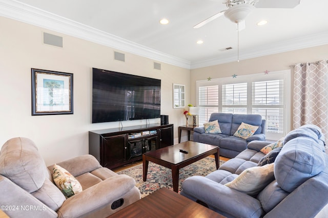 living room featuring hardwood / wood-style floors, ornamental molding, and ceiling fan