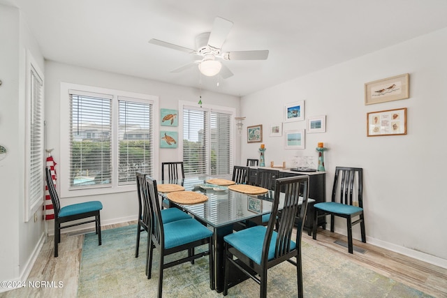 dining space featuring ceiling fan and light wood-type flooring