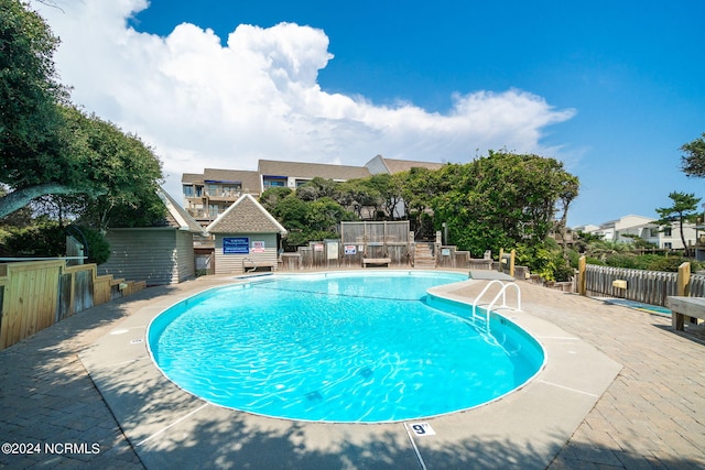 view of swimming pool featuring a patio area