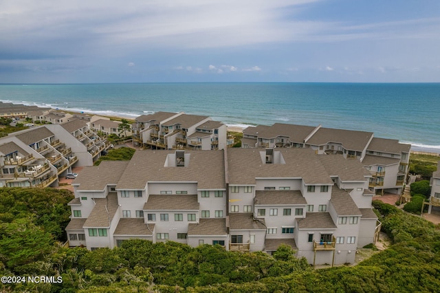 drone / aerial view featuring a water view and a view of the beach