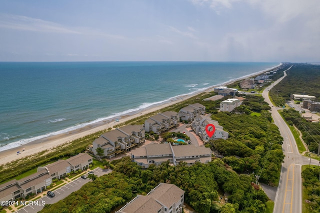 bird's eye view featuring a water view and a beach view