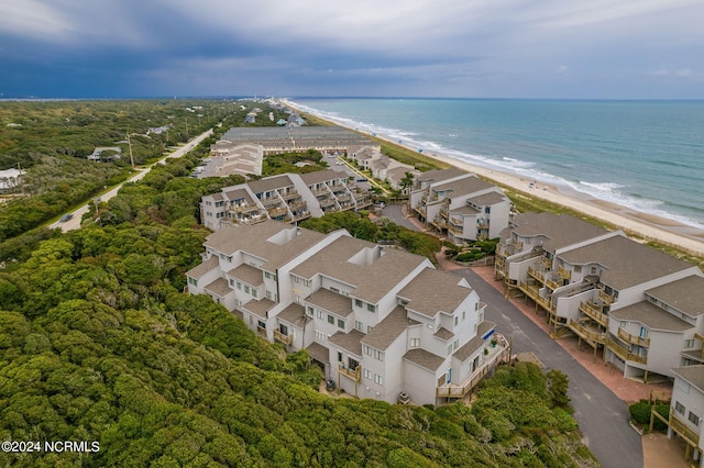 drone / aerial view featuring a water view and a beach view