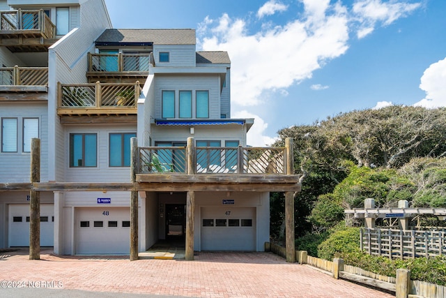 view of front of house with a garage and a balcony