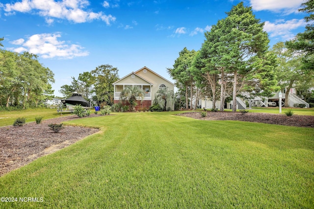 view of front of property with a front yard and brick siding