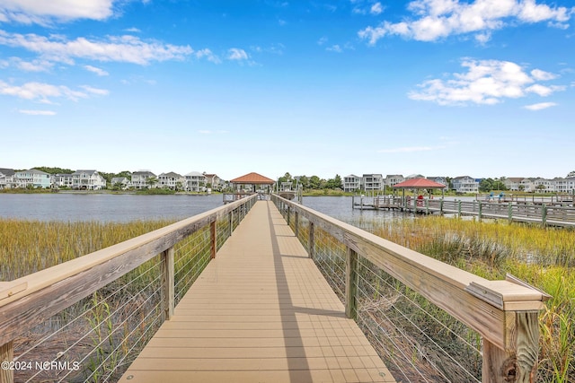 dock area featuring a water view, a residential view, and a gazebo