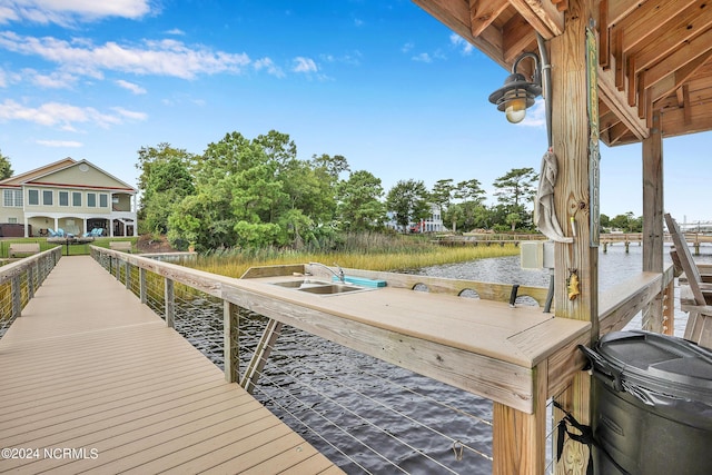 dock area with a water view and a sink