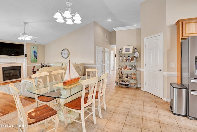 dining space featuring ceiling fan with notable chandelier, crown molding, and light hardwood / wood-style flooring