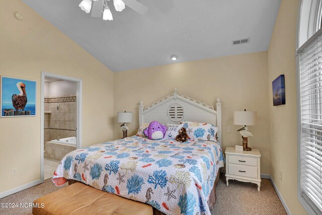 carpeted bedroom with ceiling fan, multiple windows, and ensuite bathroom