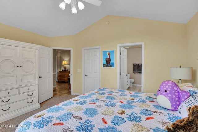 bedroom featuring light tile patterned flooring, vaulted ceiling, ceiling fan, and ensuite bathroom