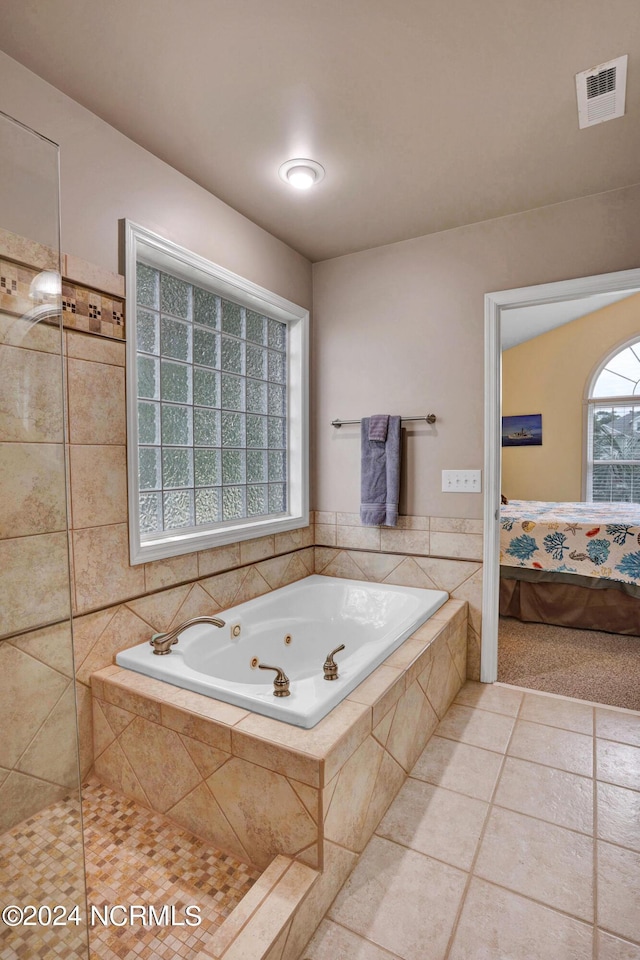 bathroom with visible vents, connected bathroom, a jetted tub, and tile patterned floors