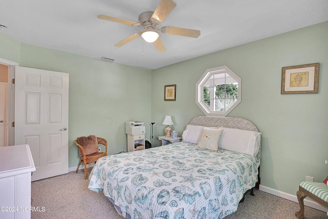 bedroom featuring baseboards, ceiling fan, visible vents, and light colored carpet