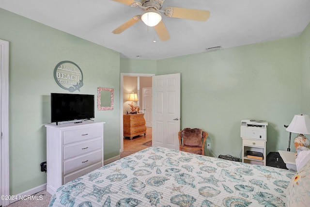 bedroom with baseboards, visible vents, and a ceiling fan