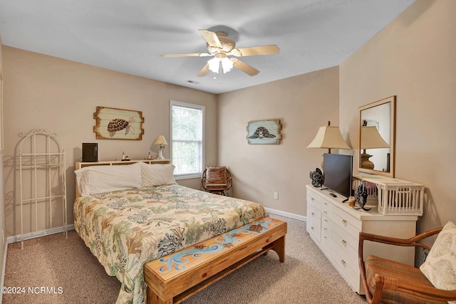 bedroom with light carpet, a ceiling fan, visible vents, and baseboards