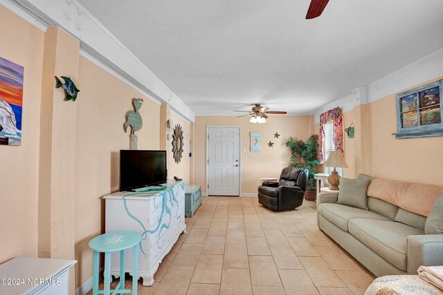 tiled living room featuring ceiling fan and ornamental molding