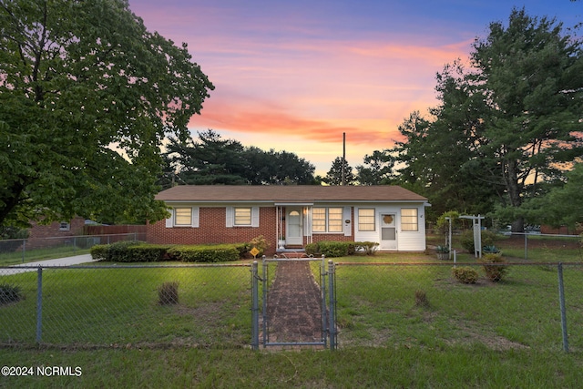 ranch-style house featuring a lawn