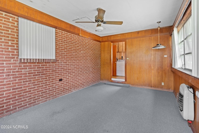 unfurnished sunroom featuring ceiling fan, heating unit, and washer / dryer