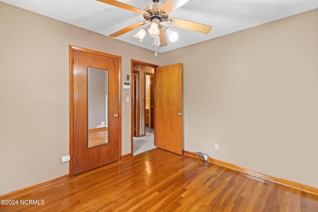 unfurnished bedroom featuring ceiling fan and wood-type flooring