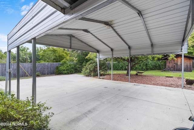 view of patio / terrace with a shed and a carport