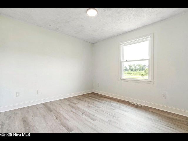 9348 NC Highway 210, Rocky Point, NC 28457 - unfurnished room with light wood-style floors, baseboards, and a textured ceiling
